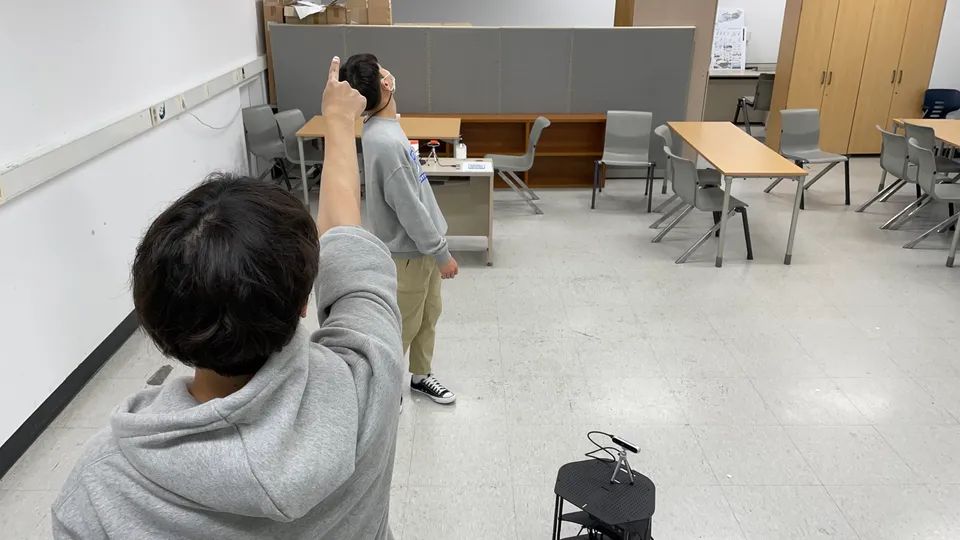 Participant using a deictic gesture during the spatial communication experiment